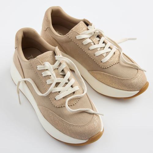 Laydown detail image of the taupe shimmer TRVL Lite wedge sneaker